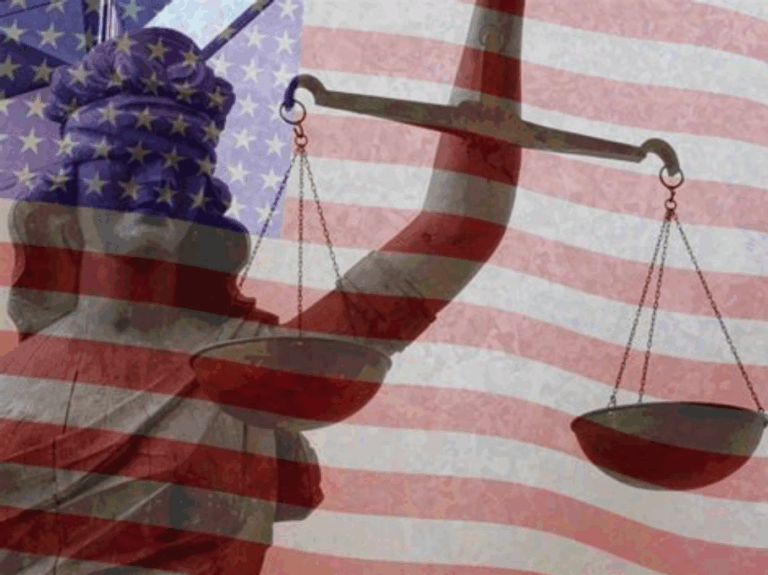 A translucent red, white, and blue American flag waves in the background behind a blindfolded Lady Justice holding scales.